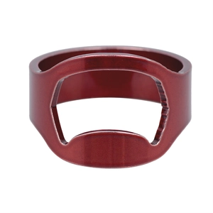 Close-up of red stainless steel bottle opener ring with a polished metallic finish
