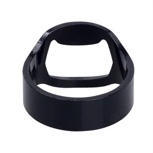 Macro shot of 45-degree angle black stainless steel ring bottle opener on white backdrop