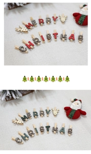 Detail of colorful wooden Christmas clips with reindeer and Merry Christmas letters