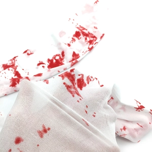 Detail of Halloween nurse stockings showing realistic red blood splatter on white fabric
