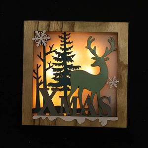 Illuminated Christmas wooden lightbox featuring deer and forest silhouette designs