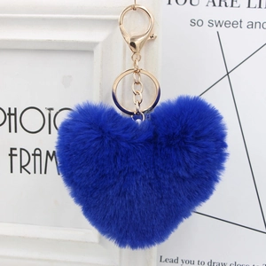 Close-up of blue heart plush keychain with golden metal ring and lobster clasp