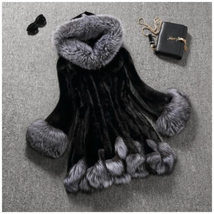 Women's black mid-length faux fur hooded coat with grey fox fur trim shown on grey ground