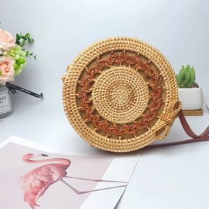 Handcrafted round rattan crossbody bag with wave pattern and leather shoulder strap