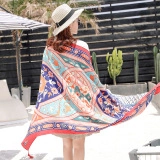 Close-up of lightweight cotton linen shawl with vibrant ethnic patterns in outdoor setting
