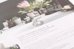 Close-up of S925 sterling silver wavy and twisted rings on an open magazine page