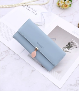 Detail of light blue PU leather long wallet featuring a pink leaf metal pendant charm