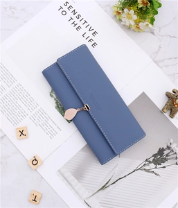 Detail of blue PU leather long wallet featuring leaf pendant and white contrast stitching