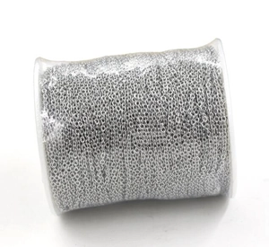 Close-up of 2mm silver cross chain link roll on transparent spool for DIY jewelry