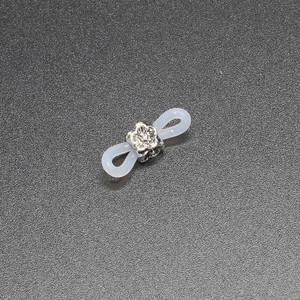 Macro view of silver flower metal beads with transparent silicone loops for glasses