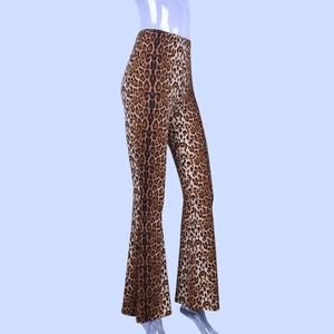 Detail showing high waist elastic band and leopard print texture on flared trousers