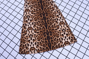 Close-up of leopard print flare pants showing detailed fabric texture and hem stitching