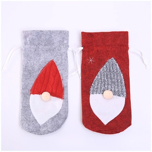 Christmas gnome wine bottle covers in red and grey felt with knit hats and drawstrings