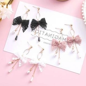Three-piece set of lace bow earrings with pearls and metal tassels in pink, black, and white