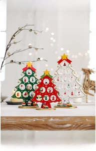 Close-up of DIY wooden Christmas tree set with miniature pendants and a toy train base