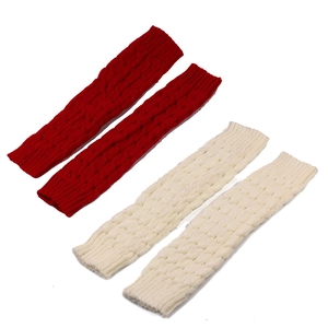 Detail view of chunky knit leg warmers in red and off-white with cable knit texture