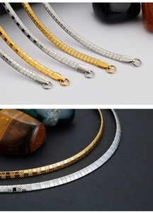 Detailed close-up of 4mm herringbone chain necklaces with textured gold and silver finishes