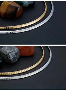 Detail of 4mm titanium steel omega necklaces in gold and silver with textured finish