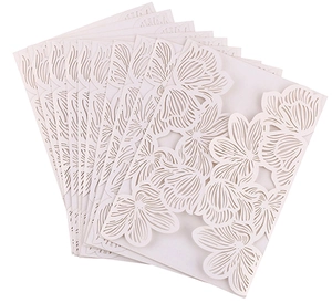 Detailed laser-cut white cardstock with intricate floral patterns for wedding invitations