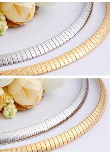 Close-up of 6mm snake chain necklaces in gold and silver showing etched and smooth finishes