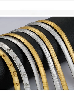 Detail of 6mm flat snake chain with engraved geometric patterns in gold and silver