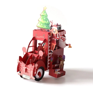 3D pop-up Christmas card featuring Santa in a red vintage truck with reindeer and tree