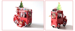 3D pop-up Christmas card featuring a red double-decker bus with Santa and reindeer