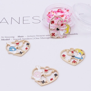 Detail of heart-shaped Alice in Wonderland alloy pendants with colorful enamel drip