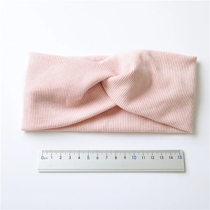 Light pink knitted twist headband for women, showing 14cm folded length with a ruler