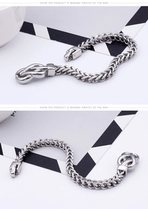 Detailed macro view of men's silver stainless steel dragon bone weave bracelet with clasp