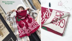 Detailed view of wine red Christmas scarf featuring reindeer patterns and soft knit fabric