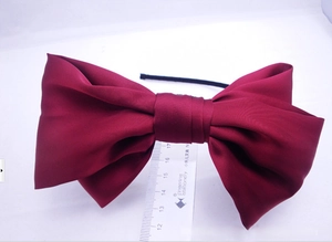 Detailed view showing the dimensions of the oversized wine red satin bow headband