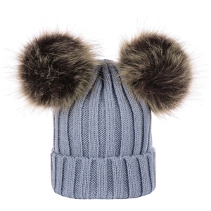 Blue knitted winter hat for infants with two brown faux fur pom poms on white background