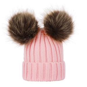 Pink knit baby beanie featuring two large brown faux fur pom poms on top for winter