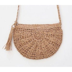 Close-up of semi-circle straw crossbody bag with radial weave and tassel details