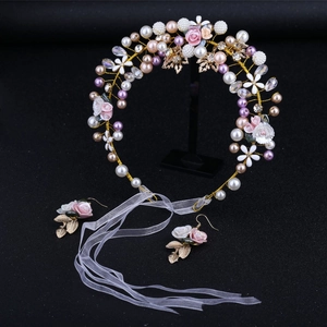 Pink ceramic flower and pearl bridal headband set with matching earrings on black background