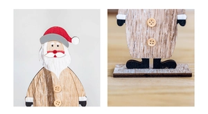 Detail of wooden Santa figurine showing natural grain, hand-painted finish and base