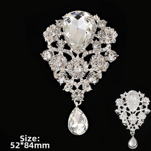 Detailed view of a silver rhinestone flower brooch with a teardrop pendant 52x84mm