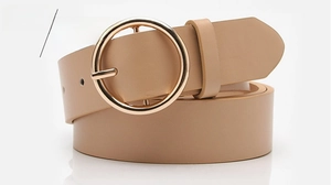 Detail of khaki leather belt with a round golden buckle for casual women's fashion outfits
