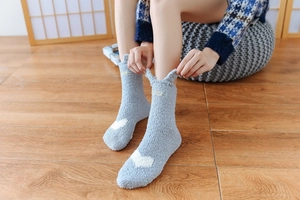 Blue fuzzy coral fleece socks with cute bunny ears and white heart pattern detail
