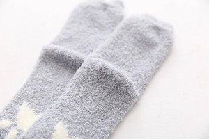 Close-up of thick grey coral fleece socks showing soft plush texture and fuzzy material