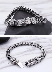 Detail of double woven chain bracelet with Egyptian Ankh cross engraving on buckle clasp