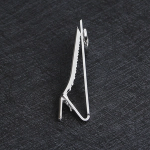 Detailed side view of silver musical note tie clip showing spring clamp and serrated grip