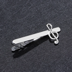 Macro shot of silver treble clef tie clip for men with polished metal finish