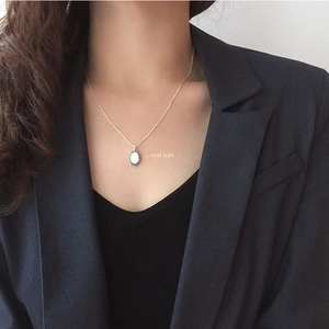 Chic S925 sterling silver necklace featuring a white oval pendant on a female model