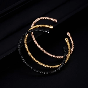 Three-piece stainless steel cable wire cuff bracelets in rose gold, gold, and black colors