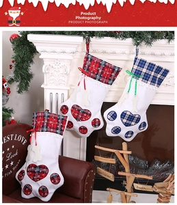 Detail of paw-shaped plaid Christmas stockings with heart patterns and bone charms