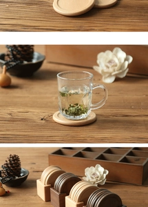 Detail of round walnut wood coasters with storage rack and glass tea cup setting
