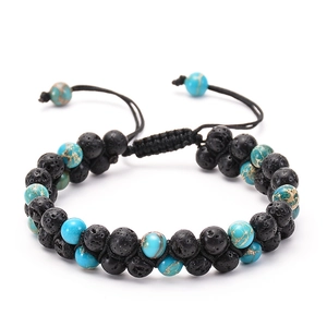 Detail of double-layer volcanic lava stone and turquoise beaded bracelet with braided cord