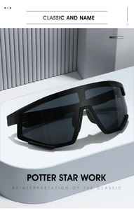 Detailed view of matte black oversized sports sunglasses on a minimalist podium